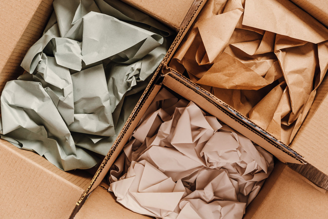 Cardboard boxes with crumpled paper inside for packaging goods from online stores, eco friendly packaging made of recyclable raw materials